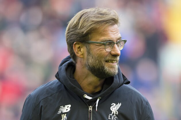 Liverpool's manager Juergen Klopp watches as his players warm up before the English Premier League soccer match between Liverpool and Tottenham Hotspur at Anfield Stadium, Liverpool, England, Saturday, April 2, 2016. (AP Photo/Jon Super)