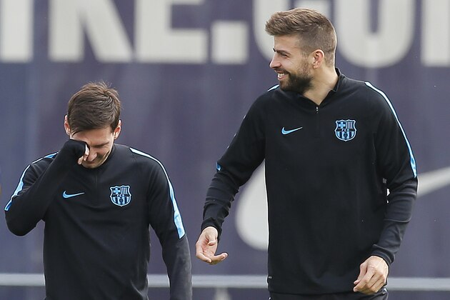 FC Barcelona's Lionel Messi, left, and Gerard Pique attend a training session at the Sports Center FC Barcelona Joan Gamper in San Joan Despi, Spain, Monday, April 4, 2016.  FC Barcelona will play against Atletico Madrid in a Champions League soccer match on Tuesday April 5. (AP Photo/Manu Fernandez)