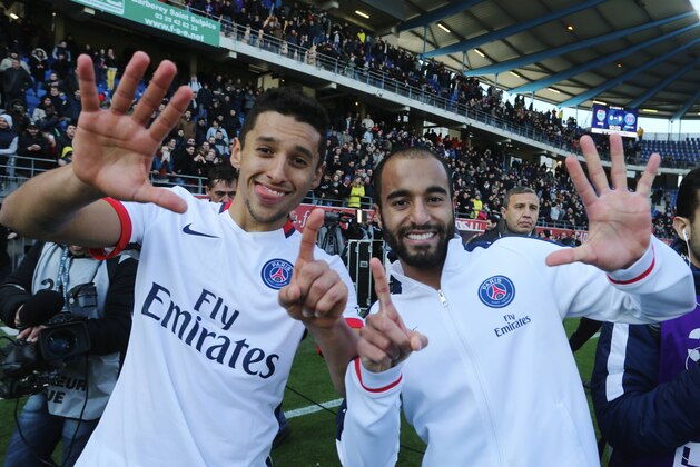 TROYES, FRANCE - MARCH 13:  Marquinhos and Lucas Moura of Paris Saint-Germain celebrate the victory of championship after the French  Ligue 1 between ESTAC Troyes and Paris Saint-Germain at Stade de l'Aube on march 13, 2016 in Troyes, France.  (Photo by Xavier Laine/Getty Images)