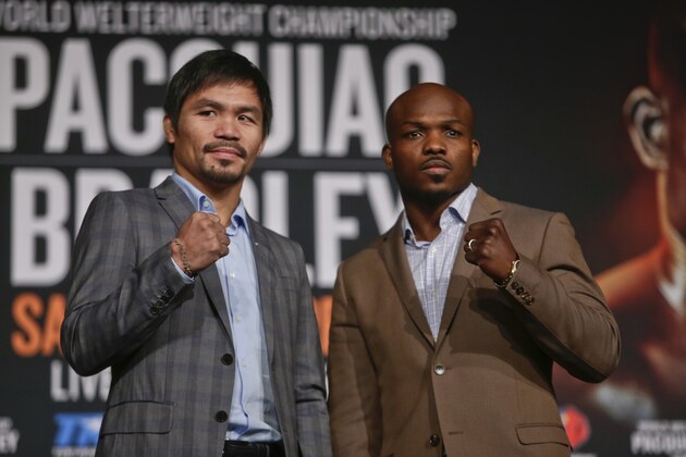 Manny Pacquiao, left, and Timothy Bradley pose for photographs during a news conference to promote an upcoming boxing match Thursday, Jan. 21, 2016, in New York.  (AP Photo/Frank Franklin II)