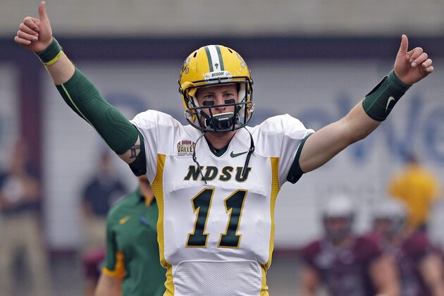 North Dakota State quarterback Carson Wentz (11) warms up before the start of their NCAA college football game against Montana Saturday, Aug. 29, 2015, in Missoula, in Mont.  (AP Photo/Rick Bowmer)