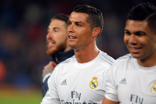 Real Madrid's Cristiano Ronaldo, center, leaves the pitch with Sergio Ramos, left, and  Casemiro at the end of a Spanish La Liga soccer match between Barcelona and Real Madrid, dubbed 'el clasico', at the Camp Nou stadium in Barcelona, Spain, Saturday, April 2, 2016. Ronaldo scored the second goal in Ream Madrid's 2-1 win. (AP Photo/Manu Fernandez)