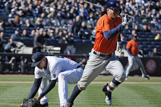 New York Yankees relief pitcher Dellin Betances (68) picks up Carlos Correa's eighth-inning infield roller as Correa races to first base in an opening day baseball game in New York, Tuesday, April 5, 2016. Correa reached on a Betances throwing error. The Astros Jose Altuve scored on the play. (AP Photo/Kathy Willens)