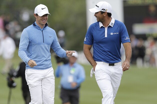 Rory McIlroy, left, of Northern Ireland, and Jason Day, of Australia, walk to the 13th green during the semifinal round at the Dell Match Play Championship golf tournament at Austin Country Club, Sunday, March 27, 2016, in Austin, Texas. (AP Photo/Eric Gay)