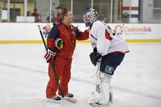 Washington Capitals goaltending coach Mitch Korn, left, talks with Mark Dekanich, right, during Media Day at NHL hockey training camp, Friday, Sept. 18, 2015, in Arlington, Va. (AP Photo/Nick Wass)