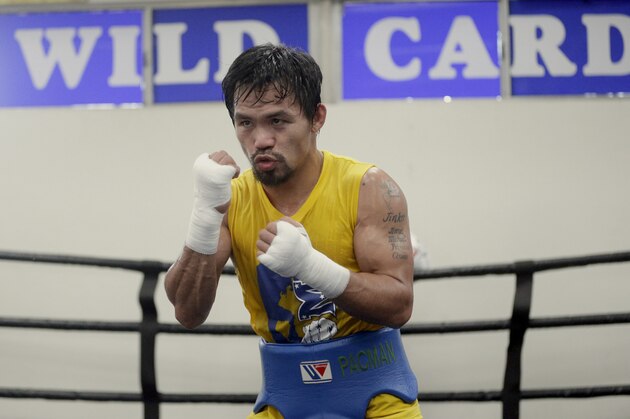 In this Monday, April 4, 2016, photo, boxer Manny Pacquiao, of the Philippines works out in front of reporters and photographers at the Wild Card gym in Los Angeles. Pacquiao is scheduled to fight Timothy Bradley in Las Vegas on Saturday, April 9. (AP Photo/Nick Ut)