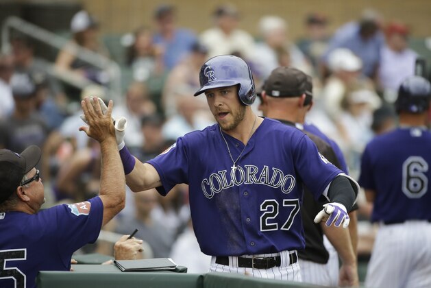 Colorado Rockies' Trevor Story celebrates his home run during a spring training baseball game against the Chicago White Sox Monday, March 28, 2016, in Scottsdale, Ariz. (AP Photo/Jae C. Hong)
