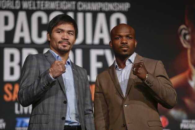 Manny Pacquiao, left, and Timothy Bradley pose for photographs during a news conference to promote an upcoming boxing match Thursday, Jan. 21, 2016, in New York.  (AP Photo/Frank Franklin II)