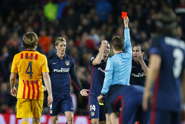 Atletico's Fernando Torres, 2nd left is shown a red card by Referee Felix Brych during a Champions League quarter-final, first leg soccer match between FC Barcelona and Atletico Madrid at the Camp Nou stadium in Barcelona, Spain, Tuesday April 5, 2016. (AP Photo/Manu Fernandez)