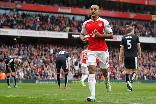 Arsenal's English midfielder Theo Walcott (C) celebrates after scoring during the English Premier League football match between Arsenal and Watford at the Emirates Stadium in London on April 2, 2016.  / AFP / Ian Kington / RESTRICTED TO EDITORIAL USE. No use with unauthorized audio, video, data, fixture lists, club/league logos or 'live' services. Online in-match use limited to 75 images, no video emulation. No use in betting, games or single club/league/player publications.  /         (Photo credit should read IAN KINGTON/AFP/Getty Images)