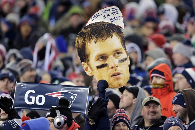 New England Patriots fans hold a picture and sign referring to Patriots quarterback Tom Brady in the first half of an NFL football game against the Buffalo Bills, Monday, Nov. 23, 2015, in Foxborough, Mass. (AP Photo/Charles Krupa)