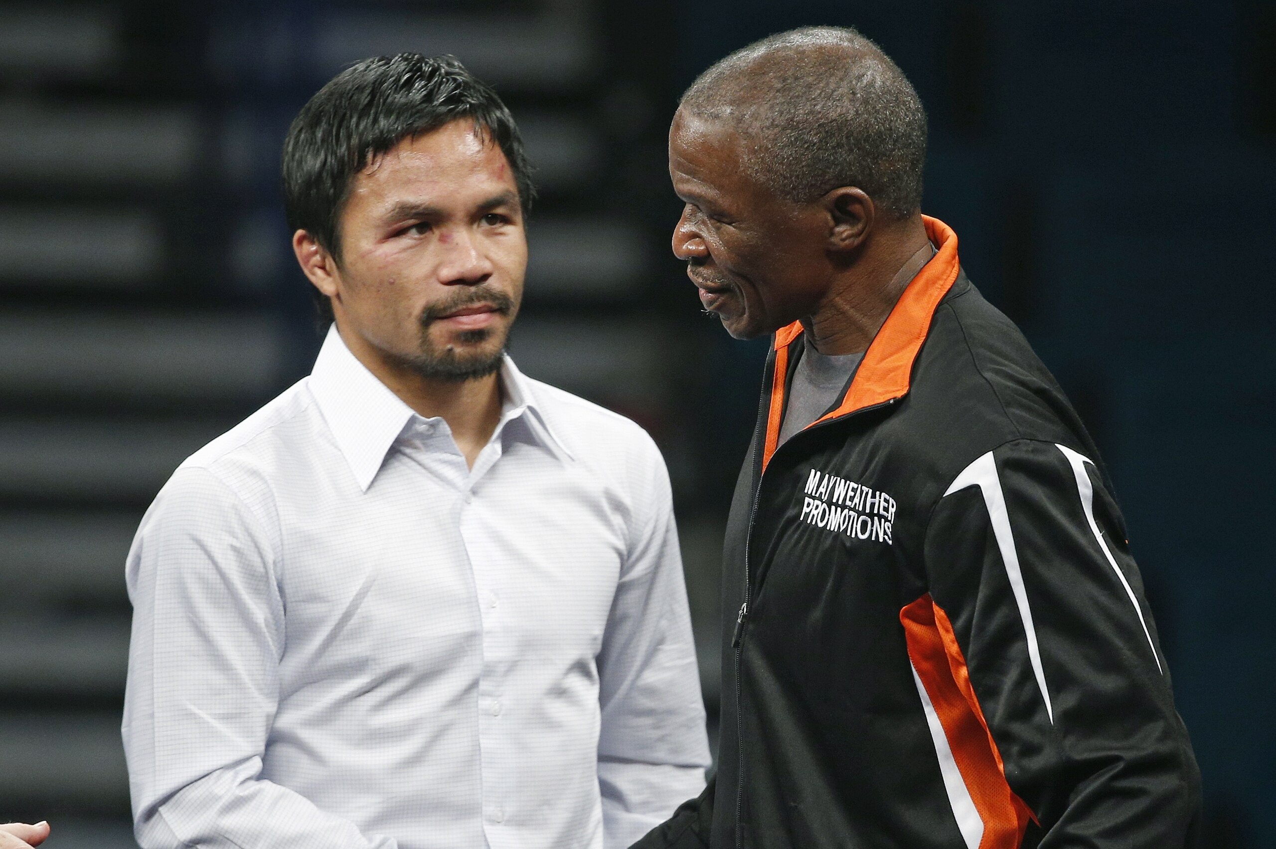 Manny Pacquiao, left, shakes hands with Floyd Mayweather Sr. during a press conference following their welterweight title fight on Saturday, May 2, 2015 in Las Vegas. Mayweather defeated Pacquiao in a unanimous decision. (AP Photo/John Locher)
