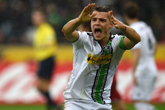 Moenchengladbach's Swiss midfielder Granit Xhaka reacts during the German first division Bundesliga football match Borussia Moenchengladbach vs 1. FC Cologne in Moenchengladbach , western Germany, on February  20, 2016. / AFP / PATRIK STOLLARZ / RESTRICTIONS: DURING MATCH TIME: DFL RULES TO LIMIT THE ONLINE USAGE TO 15 PICTURES PER MATCH AND FORBID IMAGE SEQUENCES TO SIMULATE VIDEO. == RESTRICTED TO EDITORIAL USE == FOR FURTHER QUERIES PLEASE CONTACT DFL DIRECTLY AT + 49 69 650050
        (Photo credit should read PATRIK STOLLARZ/AFP/Getty Images)