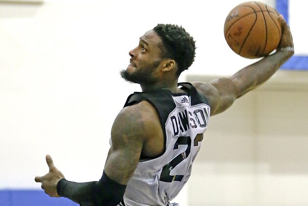 FILE - In this July 7, 2015 file photo, Los Angeles Clippers' Branden Dawson goes in for an uncontested dunk against the Oklahoma City Thunder during an NBA summer league basketball game in Orlando, Fla. The Los Angeles Police Department reported that Dawson has been arrested on suspicion of spousal abuse and taken into custody at his home in the Playa Vista area of Los Angeles around 7:30 a.m. Sunday, March 13, 2016. He was released on $50,000 bail about six hours later. (AP Photo/John Raoux)