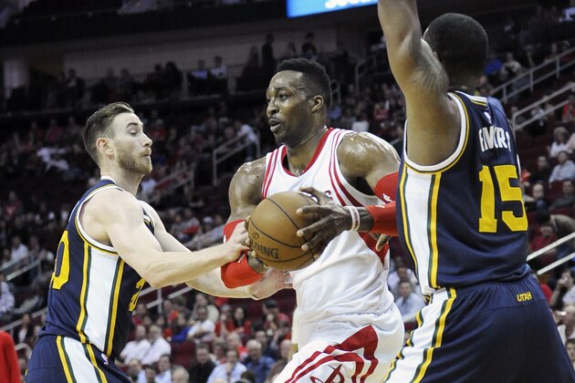 Houston Rockets' Dwight Howard (12) is double-teamed by Utah Jazz's Gordon Hayward (20) and Derrick Favors (15) in the first half of an NBA basketball game Wednesday, March 23, 2016, in Houston. (AP Photo/Pat Sullivan)