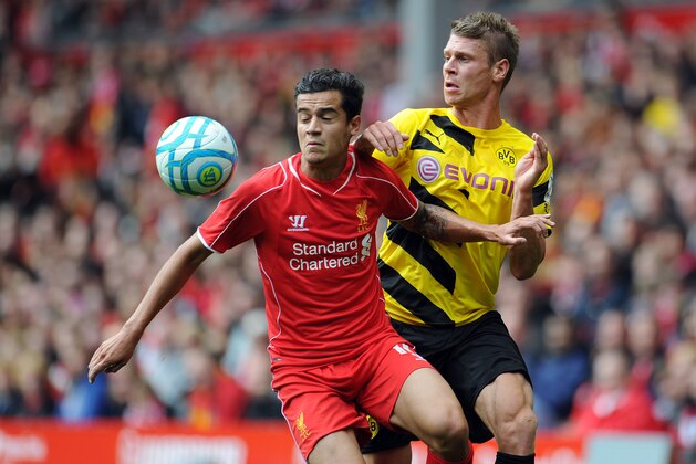 LIVERPOOL, ENGLAND - AUGUST 10:  Philippe Coutinho of Liverpool and Lukasz Piszczek of Borussia Dortmund battle for the ball during the Pre Season Friendly match between Liverpool and Borussia Dortmund at Anfield on August 10, 2014 in Liverpool, England. (Photo by Clint Hughes/Getty Images)