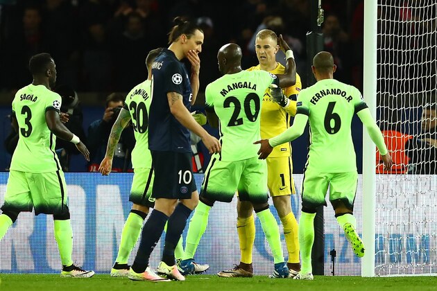 PARIS, FRANCE - APRIL 06:  Joe Hart (2nd R) of Manchester City is congratulated by his team mates on stopping a penalty by Zlatan Ibrahimovic (3rd L) of Paris Saint-Germain during the UEFA Champions League Quarter Final First Leg match between Paris Saint-Germain and Manchester City at Parc des Princes on April 6, 2016 in Paris, France.  (Photo by Clive Rose/Getty Images)