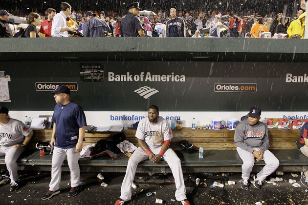 Boston Red Sox designated hitter David Ortiz, center, sits in the dugout in a rain delay in the seventh inning of the Red Sox's baseball game against the Baltimore Orioles on Wednesday, Sept. 28, 2011, in Baltimore. (AP Photo/Patrick Semansky)