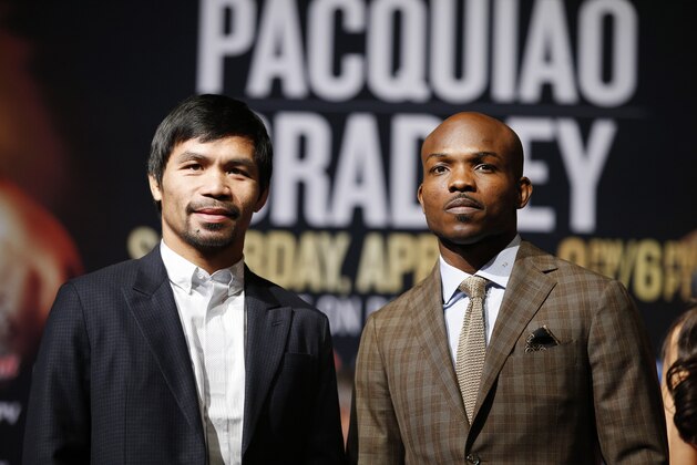 Manny Pacquiao, from the Philippines, left, poses with Timothy Bradley during a news conference, Wednesday, April 6, 2016, in Las Vegas. The two are scheduled to fight in a welterweight title fight Saturday in Las Vegas. (AP Photo/John Locher)
