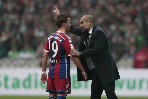 BREMEN, GERMANY - MARCH 14:  Head coach Pep Guardiola (R) of Munich talks to Mario Goetze (L) during the First Bundesliga match between SV Werder Bremen and FC Bayern Muenchen at Weserstadion on March 14, 2015 in Bremen, Germany.  (Photo by Oliver Hardt/Getty Images)