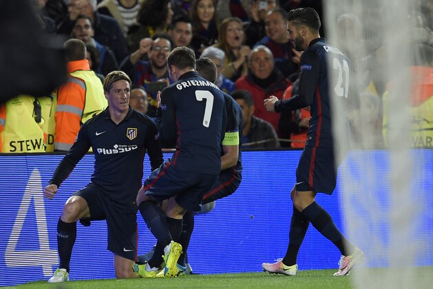 Atletico Madrid's forward Fernando Torres (L) celebrates with teammates after scoring during the UEFA Champions League quarter finals first leg football match FC Barcelona vs Atletico de Madrid at the Camp Nou stadium in Barcelona on April 5, 2016. / AFP / LLUIS GENE        (Photo credit should read LLUIS GENE/AFP/Getty Images)