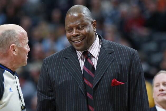 Charlotte Bobcats assistant coach Patrick Ewing confers with referee while facing the Denver Nuggets in the first quarter of an NBA basketball game in Denver on Wednesday, Jan. 29, 2014. (AP Photo/David Zalubowski)
