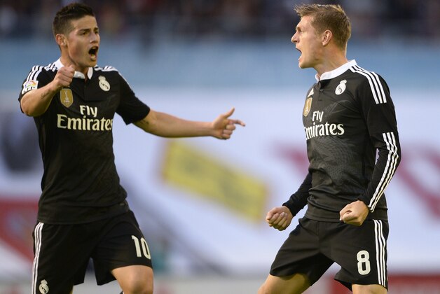 Real Madrid's German midfielder Toni Kroos (R) celebrates with teammate Colombian midfielder James Rodriguez after scoring a goal during the Spanish league football match Celta Vigo vs  Real Madrid CF at the Balaidos stadium in Vigo on April 26, 2015.  AFP PHOTO/ MIGUEL RIOPA        (Photo credit should read MIGUEL RIOPA/AFP/Getty Images)