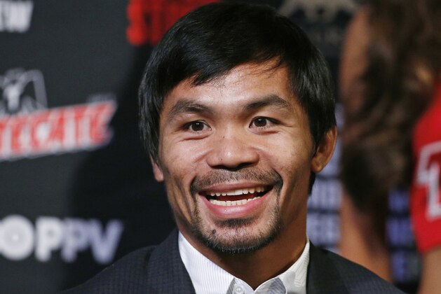 Manny Pacquiao, from the Philippines, reacts during a news conference Wednesday, April 6, 2016, in Las Vegas. Pacquiao is scheduled to fight Timothy Bradley in a welterweight title fight Saturday in Las Vegas. (AP Photo/John Locher)