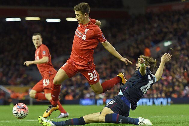Liverpool's English midfielder Cameron Brannagan (C) is challenged by West Ham United's Croatian striker Nikica Jelavic (R) during the English FA Cup fourth round football match between Liverpool and West Ham United at Anfield in Liverpool, north west England, on January 30, 2016. / AFP / PAUL ELLIS / RESTRICTED TO EDITORIAL USE. No use with unauthorized audio, video, data, fixture lists, club/league logos or 'live' services. Online in-match use limited to 75 images, no video emulation. No use in betting, games or single club/league/player publications.  /         (Photo credit should read PAUL ELLIS/AFP/Getty Images)