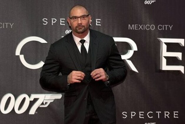 Actor Dave Bautista adjusts his jacket on the red carpet at the regional premiere of the latest James Bond film,