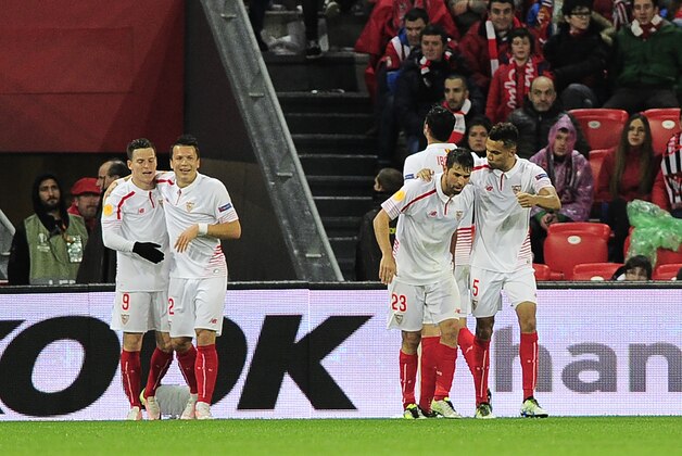Sevilla's players celebrate after scoring during the UEFA Europa League quarter finals first leg football match Athletic Club Bilbao vs Sevilla FC at the San Mames stadium in Bilbao on April 7, 2016. / AFP / ANDER GILLENEA        (Photo credit should read ANDER GILLENEA/AFP/Getty Images)