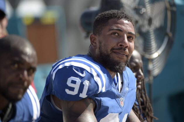 Indianapolis Colts linebacker Jonathan Newsome (91) and running back Ahmad Bradshaw, left, watch from the bench during the second half of an NFL football game against the Jacksonville Jaguars in Jacksonville, Fla., Sunday, Sept. 21, 2014.(AP Photo/Phelan M. Ebenhack)