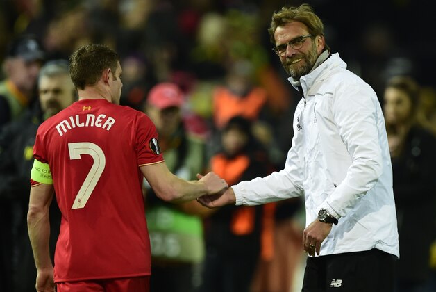 Liverpool's German head coach Jurgen Klopp (R) shakes hands with Liverpool's English midfielder James Milner after the UEFA Europe League quarter-final, first-leg football match Borussia Dortmund vs Liverpool FC in Dortmund, western Germany on April 7, 2016.
The match ended with a 1-1 draw. / AFP / John MACDOUGALL        (Photo credit should read JOHN MACDOUGALL/AFP/Getty Images)