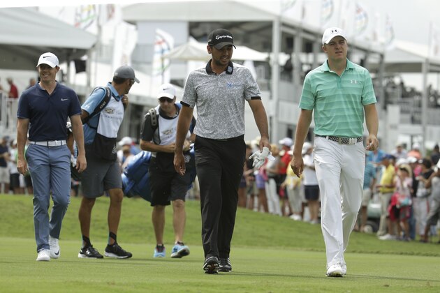 Rory McIlroy, of Northern Ireland, left, walks with Jason Day, of Australia, center, and Jordan Spieth, right, during the first round of the Cadillac Championship golf tournament, Thursday, March 3, 2016, in Doral, Fla. (AP Photo/Lynne Sladky)