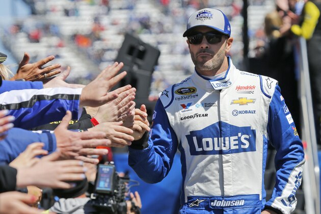 Driver Jimmie Johnson greets fans during driver introductions for the Sprint Cup auto race at Martinsville Speedway on Sunday, April 3, 2016, in Martinsville, Va. (AP Photo/Steve Helber)