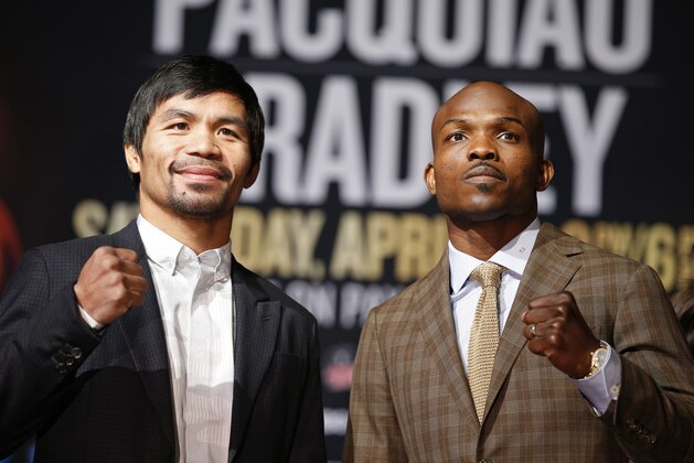 Boxers Manny Pacquiao, from the Philippines, left, poses with Timothy Bradley, Wednesday, April 6, 2016, in Las Vegas. The two are scheduled to fight in a welterweight title fight Saturday in Las Vegas. (AP Photo/John Locher)