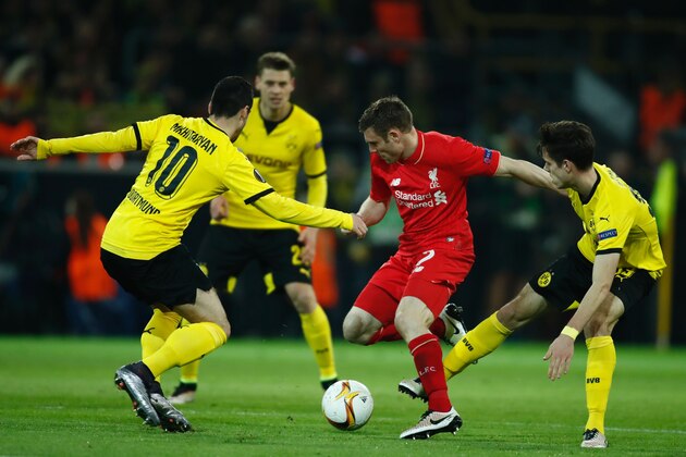 Liverpool's English midfielder James Milner (C) vies for tha ball with Dortmund's Armenian midfielder Henrikh Mkhitaryan (L) and Dortmund's midfielder Julian Weigl (R) during the UEFA Europe League quarter-final, first-leg football match Borussia Dortmund vs Liverpool FC in Dortmund, western Germany on April 7, 2016. / AFP / ODD ANDERSEN        (Photo credit should read ODD ANDERSEN/AFP/Getty Images)