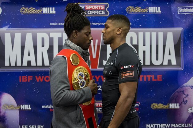IBF world heavyweight boxing champion Charles Martin, left, from the U.S, and British Olympic super heavyweight champion Anthony Joshua go head-to-head for the media after speaking in a press conference at a hotel in London, Thursday, April 7, 2016.  Martin and Joshua face each other in an IBF world heavyweight title fight at the O2 arena in London on Saturday. (AP Photo/Matt Dunham)