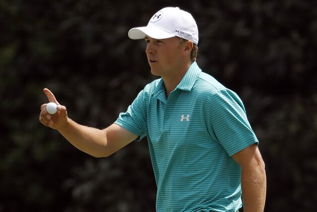 Jordan Spieth holds up his ball after putting on the 11th green during the first round of the Masters golf tournament Thursday, April 7, 2016, in Augusta, Ga. (AP Photo/Charlie Riedel)