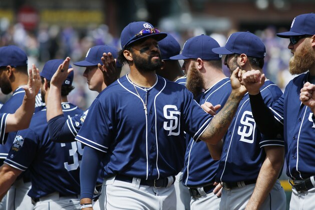 San Diego Padres right fielder Matt Kemp is welcomed to the field by teammates during introductions before facing the Colorado Rockies in a baseball game Friday, April 8, 2016, in Denver. (AP Photo/David Zalubowski)