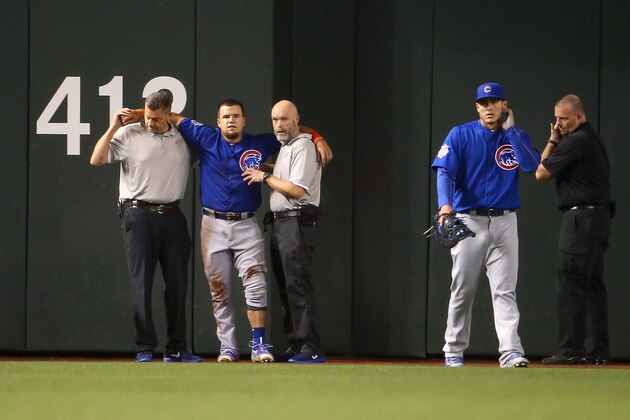 PHOENIX, AZ - APRIL 07: Outfielder Kyle Schwarber #12 of the Chicago Cubs is helped up by team trainers after an injury during the second inning of the MLB game against the Arizona Diamondbacks at Chase Field on April 7, 2016 in Phoenix, Arizona. (Photo by Christian Petersen/Getty Images) PHOENIX, AZ - APRIL 07: Outfielder Kyle Schwarber #12 of the Chicago Cubs is helped up by team trainers after an injury during the second inning of the MLB game against the Arizona Diamondbacks at Chase Field on April 7, 2016 in Phoenix, Arizona. (Photo by Christian Petersen/Getty Images)