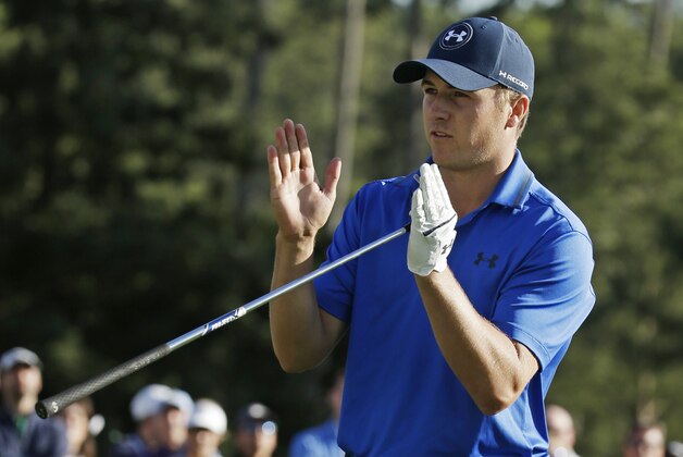 Jordan Spieth indicates how far he miss a putt for par on the 17th green on the during the second round of the Masters golf tournament Friday, April 8, 2016, in Augusta, Ga. (AP Photo/Charlie Riedel)