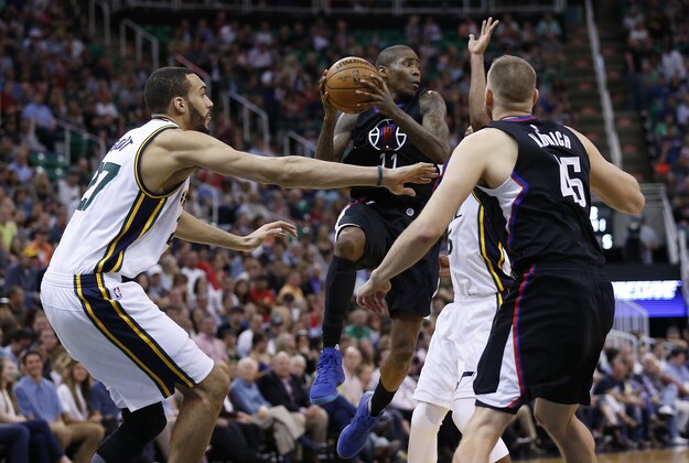 Apr 8, 2016; Salt Lake City, UT, USA; Los Angeles Clippers guard Jamal Crawford (11) looks to pass against Utah Jazz center Rudy Gobert (27) and guard Rodney Hood (5) in the second quarter at Vivint Smart Home Arena. Mandatory Credit: Jeff Swinger-USA TODAY Sports