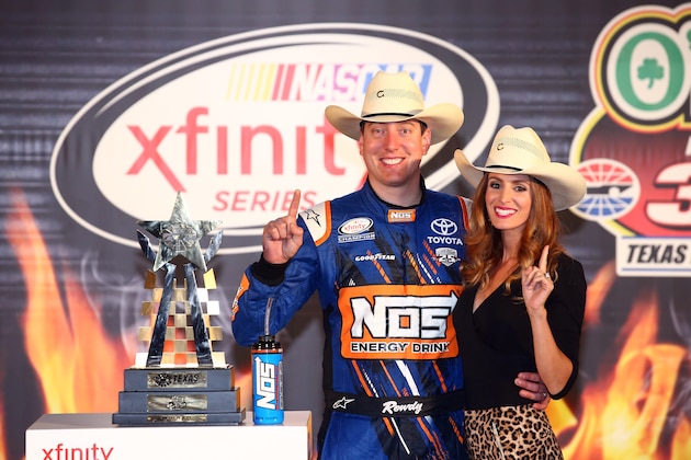 FORT WORTH, TEXAS - APRIL 08:  Kyle Busch, driver of the #18 NOS Energy Drink Toyota, poses in Victory Lane with his wife, Samantha, after winning the NASCAR XFINITY Series O'Reilly Auto Parts 300 at Texas Motor Speedway on April 8, 2016 in Fort Worth, Texas.  (Photo by Sarah Crabill/Getty Images for Texas Motor Speedway)