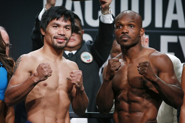 Manny Pacquiao, left, of the Philippines, and Timothy Bradley pose during a weigh-in, Friday, April 8, 2016, in Las Vegas. They are scheduled to fight in a welterweight title fight Saturday in Las Vegas. (AP Photo/John Locher)