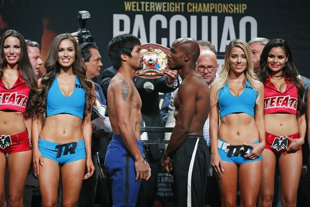 Manny Pacquiao, center left, of the Philippines, and Timothy Bradley, center right, pose during a weigh-in, Friday, April 8, 2016, in Las Vegas. The two are scheduled to fight in a welterweight title fight Saturday in Las Vegas. (AP Photo/John Locher)