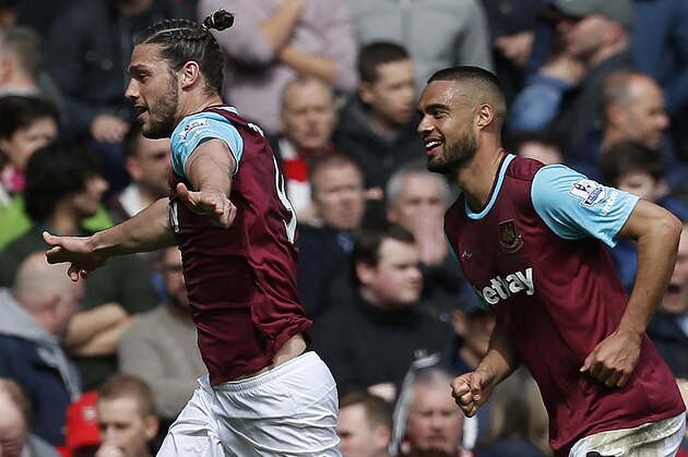 West Ham United's English striker Andy Carroll (L) celebrates scoring his team's second goal during the English Premier League football match between West Ham United and Arsenal at The Boleyn Ground in Upton Park, in east London on April 9, 2016. / AFP / Ian Kington / RESTRICTED TO EDITORIAL USE. No use with unauthorized audio, video, data, fixture lists, club/league logos or 'live' services. Online in-match use limited to 75 images, no video emulation. No use in betting, games or single club/league/player publications.  /         (Photo credit should read IAN KINGTON/AFP/Getty Images)