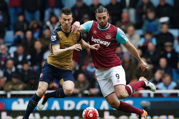 West Ham United's English striker Andy Carroll (R) vies with Arsenal's French defender Laurent Koscielny during the English Premier League football match between West Ham United and Arsenal at The Boleyn Ground in Upton Park, in east London on April 9, 2016. / AFP / Ian Kington / RESTRICTED TO EDITORIAL USE. No use with unauthorized audio, video, data, fixture lists, club/league logos or 'live' services. Online in-match use limited to 75 images, no video emulation. No use in betting, games or single club/league/player publications.  /         (Photo credit should read IAN KINGTON/AFP/Getty Images)
