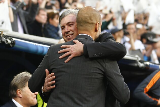 Real's coach Carlo Ancelotti hugs Bayern head coach Pep Guardiola, front, prior to a Champions League semifinal first leg soccer match between Real Madrid and Bayern Munich at the Santiago Bernabeu stadium in Madrid, Spain, Wednesday, April 23, 2014. (AP Photo/Paul White)