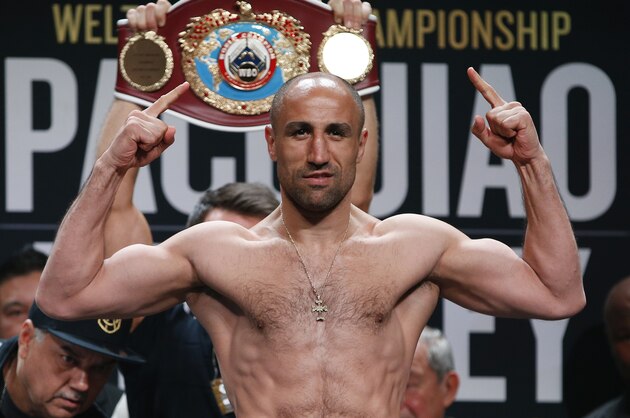 Arthur Abraham, of Germany, poses on the scale during a weigh-in, Friday, April 8, 2016, in Las Vegas. Abraham is scheduled to fight Gilberto Ramirez, of Mexico, on Saturday. (AP Photo/John Locher)